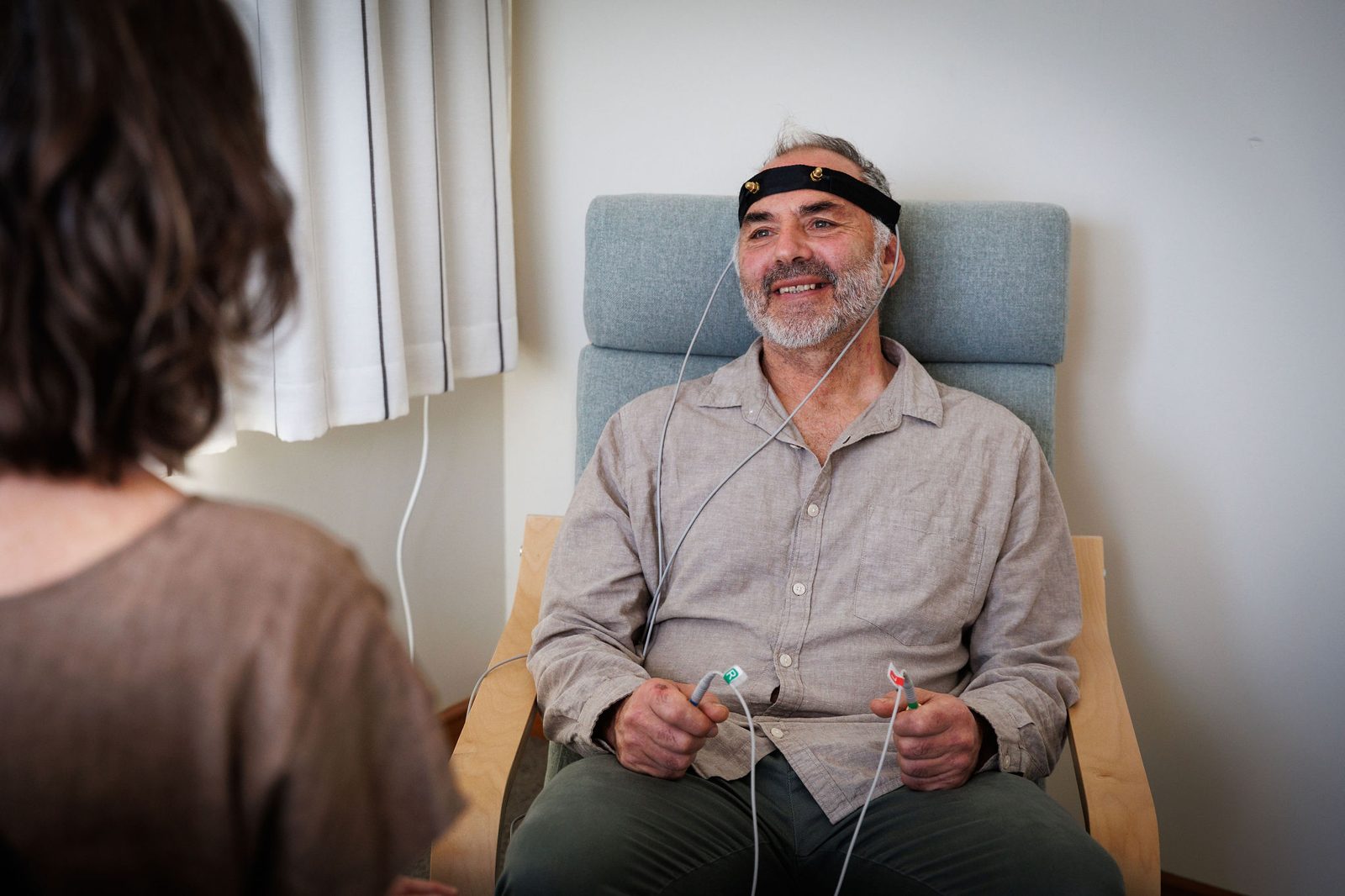 A client smiling in the studio armchair during a bioresonance session